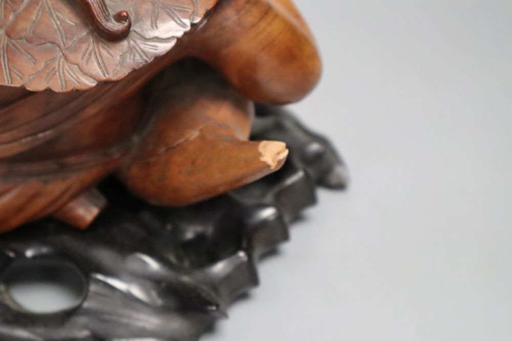 A Chinese hardwood group of Liu Hai and his three legged toad, early 20th century, together with an ebonised wood stand, length 36cm